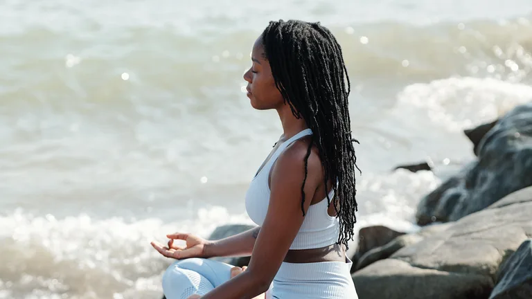 Woman in peaceful meditation by the sea — trauma therapy in the U.S. Virgin Islands